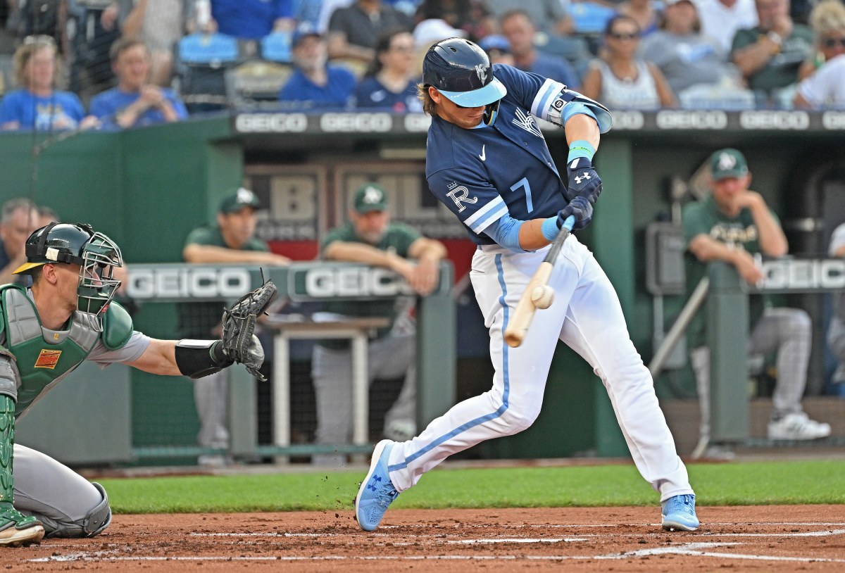 Jun 24, 2022; Kansas City, Missouri, USA; Kansas City Royals shortstop Bobby Witt Jr. (7) triples during the first inning against the Oakland Athletics at Kauffman Stadium. Mandatory Credit: Peter Aiken-USA TODAY Sports